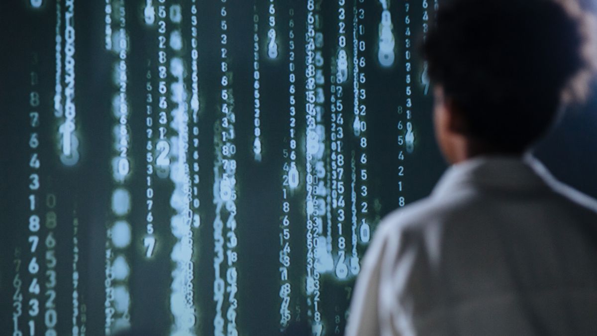 A person facing a large screen displaying data and charts, illustrating building an interactive Tableau dashboard for visual analysis