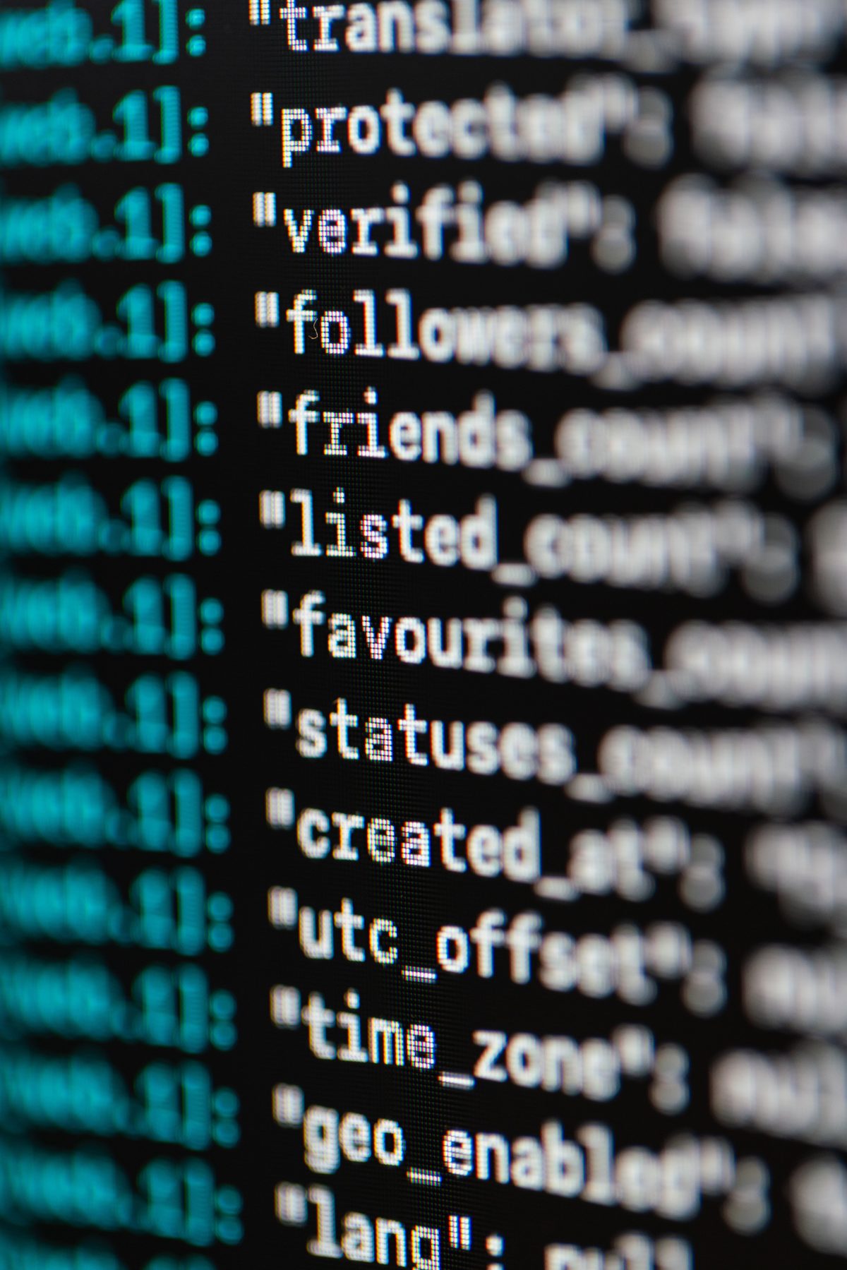 Close-up of colorful code on a computer monitor with SQL-like syntax, illustrating the query editor you use to write window functions and CTEs